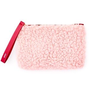 Fuzzy pink makeup‎ bag with maroon zipper pull and inner lining
IPSY